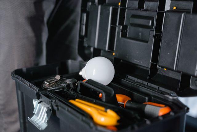 a toolbox with tools and a lightbulb